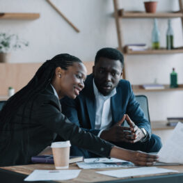african american businesspeople discussing new business project in cafe